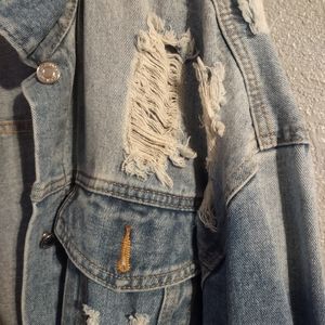 Ripped Woman's denim jacket.